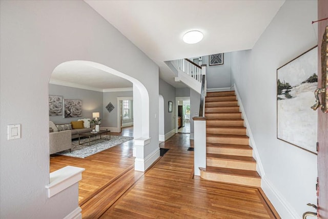 entryway featuring hardwood / wood-style floors and ornamental molding