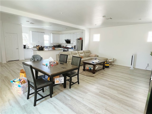 dining space featuring light wood-type flooring