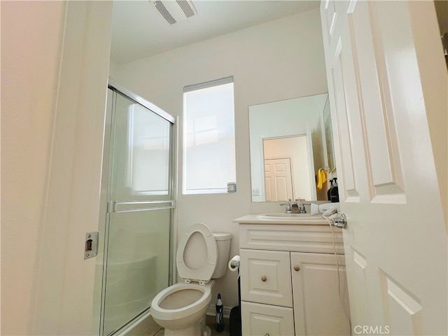 bathroom with vanity, toilet, and an enclosed shower