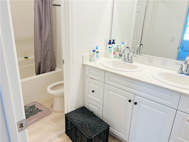 full bathroom featuring shower / tub combo with curtain, vanity, and toilet