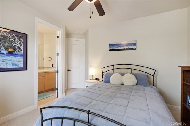 bedroom with ensuite bath, ceiling fan, and light colored carpet