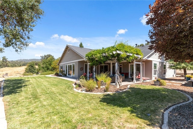 exterior space with a lawn, a patio area, and french doors