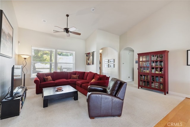 living room featuring ceiling fan, lofted ceiling, and light hardwood / wood-style floors