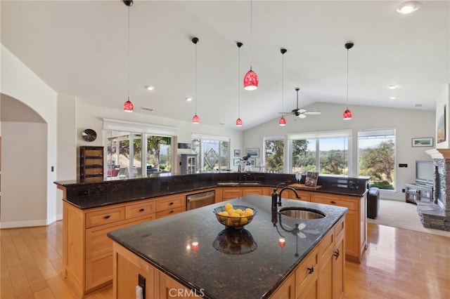 kitchen with a spacious island, ceiling fan, and a wealth of natural light