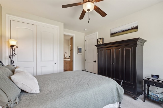 bedroom with light carpet, a closet, ensuite bath, and ceiling fan