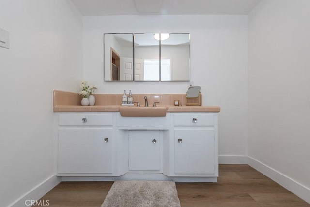 bathroom with vanity and hardwood / wood-style flooring