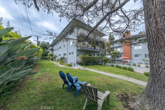 view of home's community with a lawn