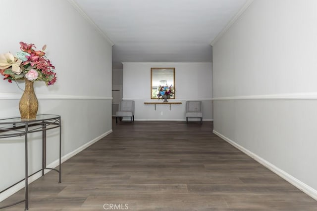 hall with dark wood-type flooring and ornamental molding