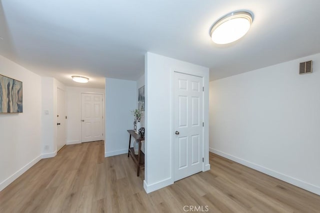 corridor with light wood-type flooring