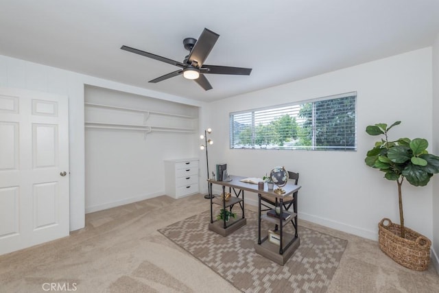 office space with ceiling fan and light colored carpet