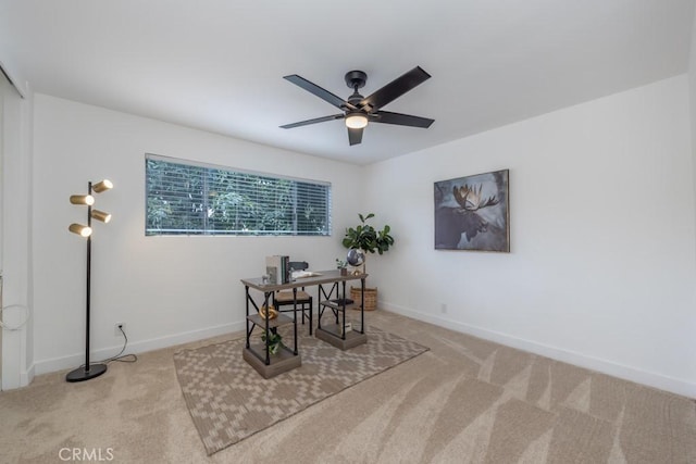 carpeted dining room featuring ceiling fan