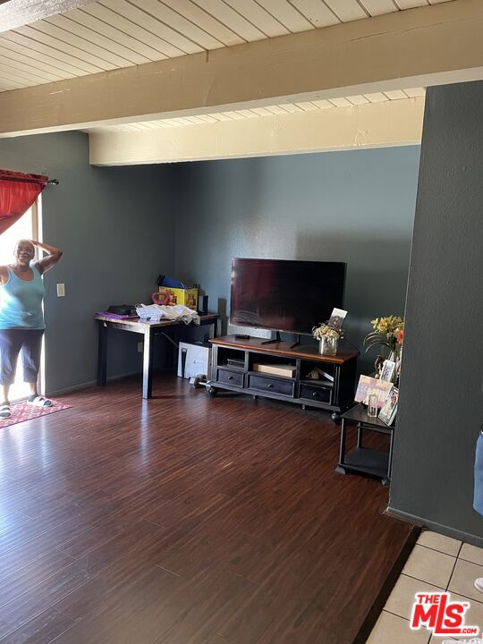 interior space with hardwood / wood-style flooring and beam ceiling