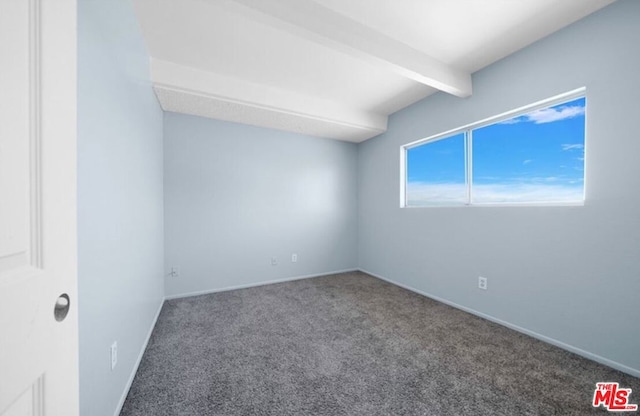 spare room with beamed ceiling and carpet floors