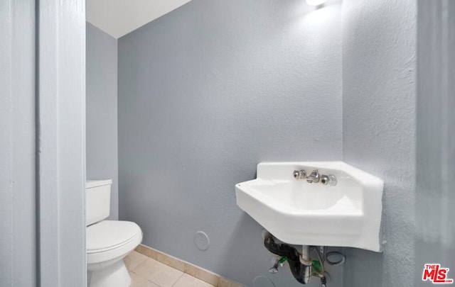 bathroom with tile patterned floors and toilet