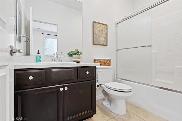 full bathroom with tile patterned flooring, vanity, toilet, and bath / shower combo with glass door