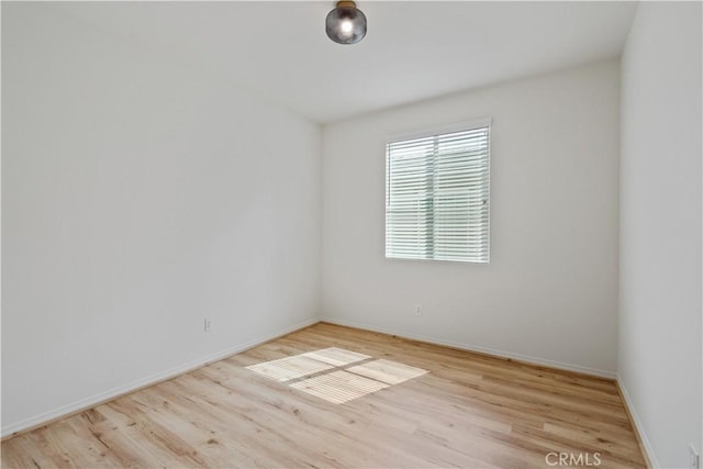 spare room featuring light wood-type flooring