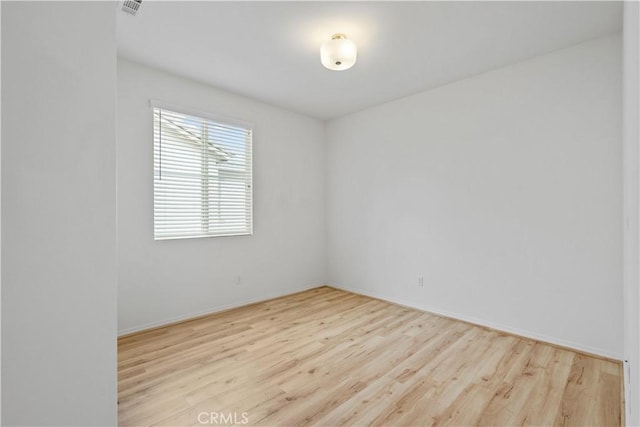 unfurnished room featuring light hardwood / wood-style floors