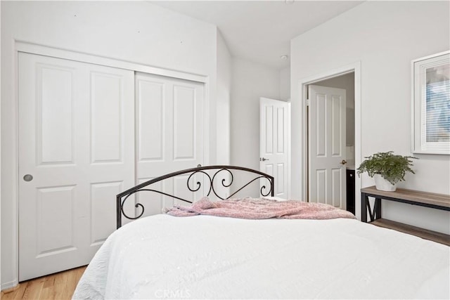 bedroom featuring light wood-type flooring and a closet