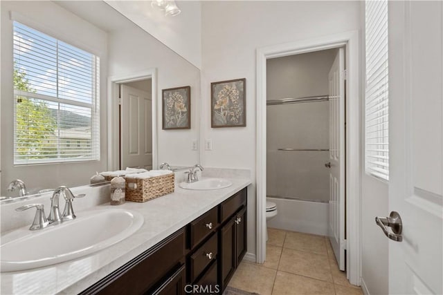 full bathroom with shower / bath combination with glass door, vanity, tile patterned floors, and toilet