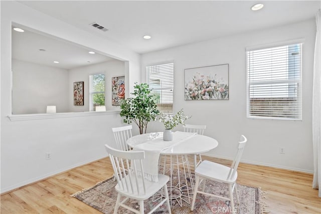 dining area with wood-type flooring and a wealth of natural light