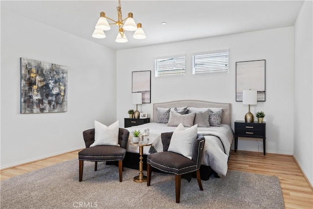 bedroom featuring hardwood / wood-style floors and an inviting chandelier