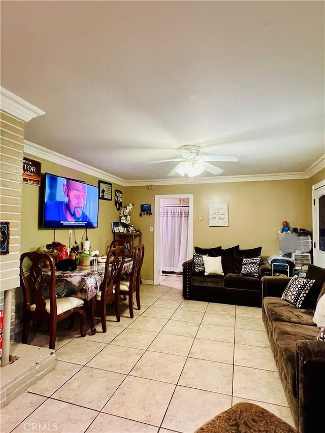 living room featuring crown molding, a fireplace, ceiling fan, and light tile patterned flooring