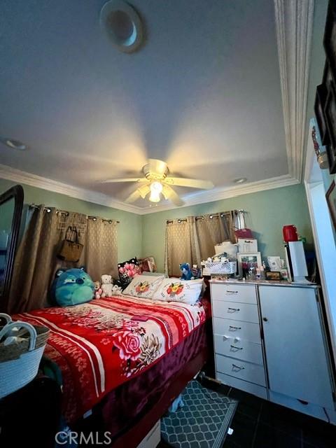 bedroom featuring crown molding, ceiling fan, and dark tile patterned flooring
