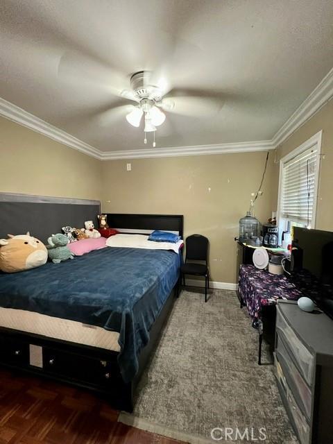 bedroom featuring ornamental molding and ceiling fan