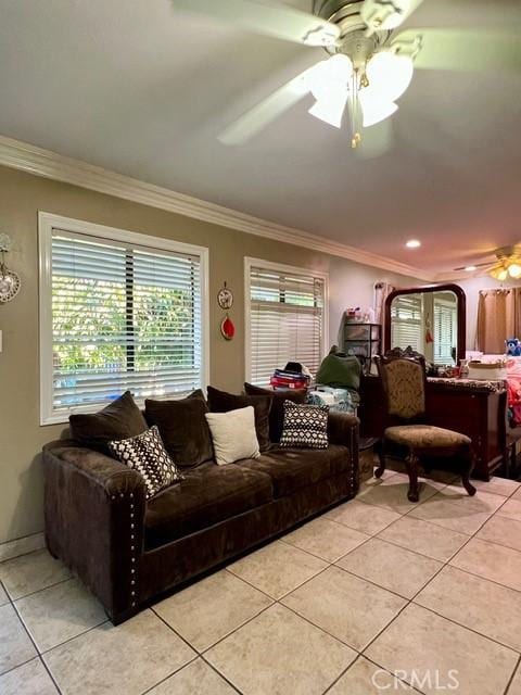 living room featuring light tile patterned floors, ornamental molding, and ceiling fan