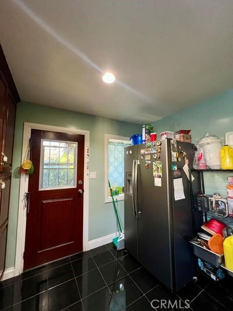 interior space with stainless steel refrigerator with ice dispenser