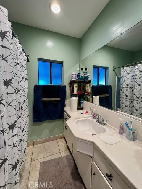 bathroom featuring vanity, curtained shower, and tile patterned flooring