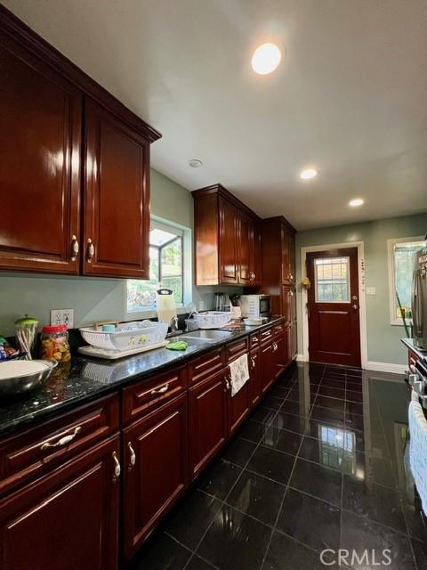 kitchen with sink and dark stone counters