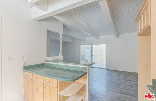 kitchen featuring beam ceiling, kitchen peninsula, dark wood-type flooring, and light brown cabinetry