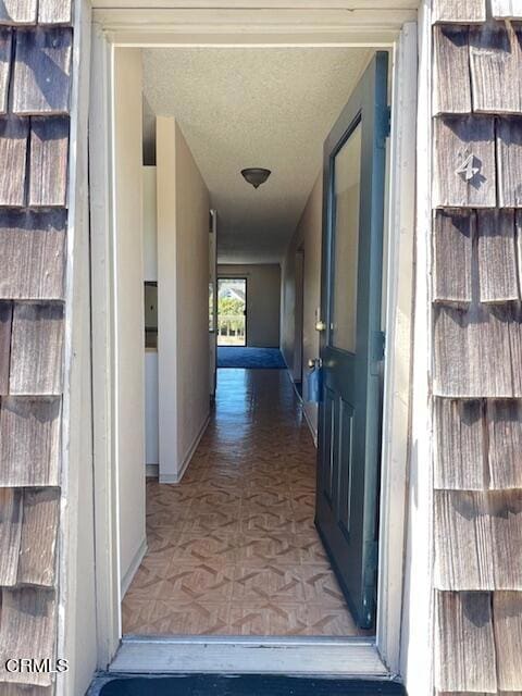 corridor with a textured ceiling