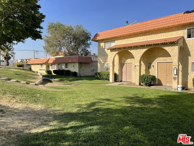 rear view of property featuring a yard