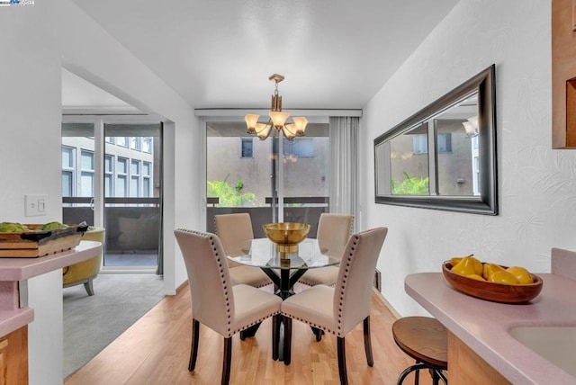 dining room featuring light hardwood / wood-style floors and a notable chandelier