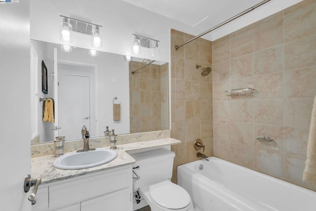 full bathroom featuring toilet, vanity, and tiled shower / bath