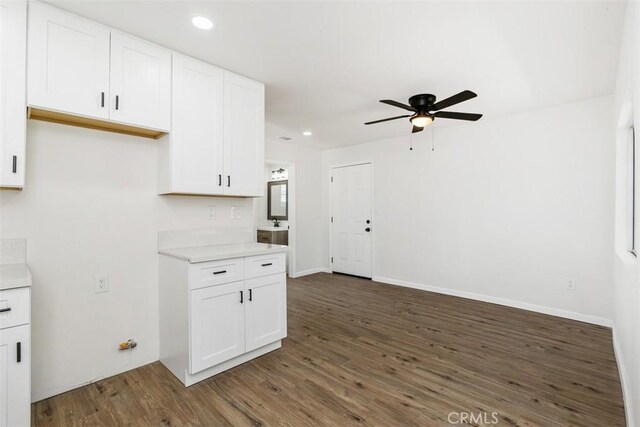 kitchen featuring ceiling fan, white cabinets, and dark hardwood / wood-style floors