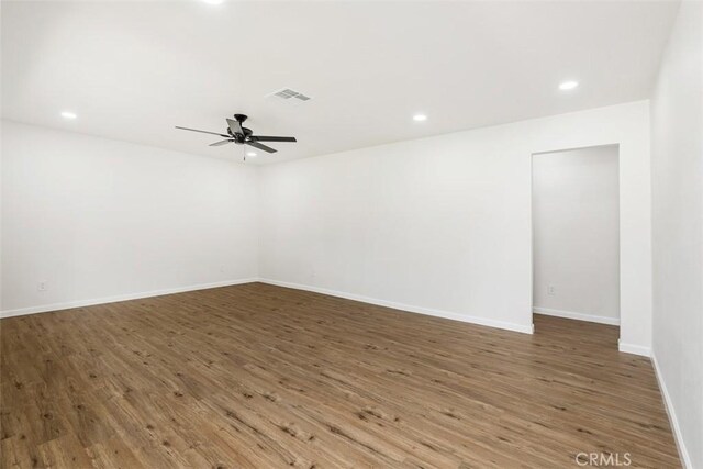 empty room featuring ceiling fan and dark hardwood / wood-style flooring