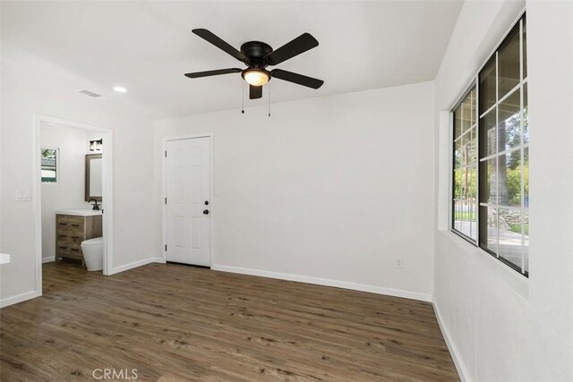 spare room with ceiling fan, dark wood-type flooring, and sink