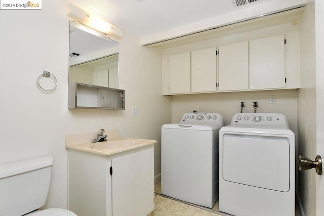 clothes washing area featuring separate washer and dryer and sink