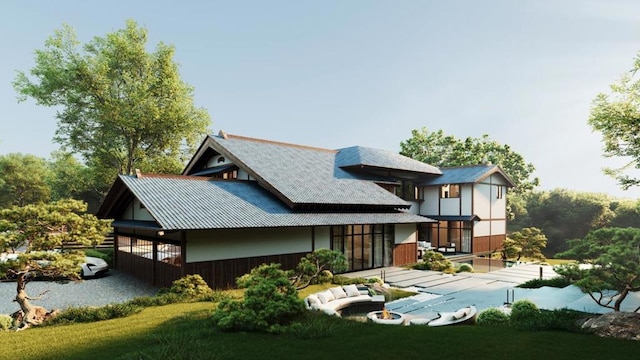 rear view of house featuring a covered pool and a lawn