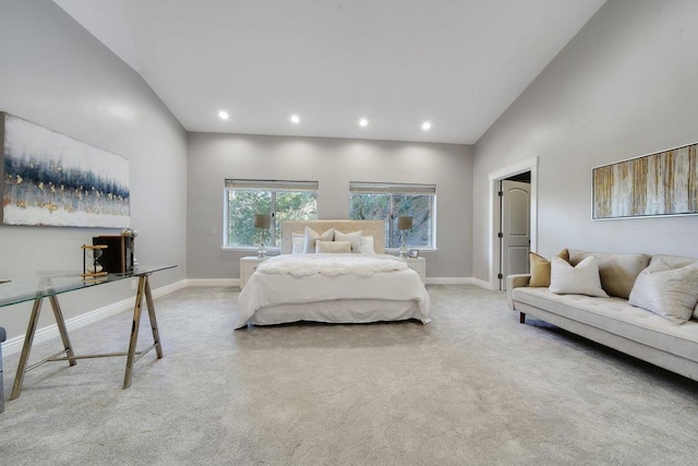 bedroom with light carpet and high vaulted ceiling