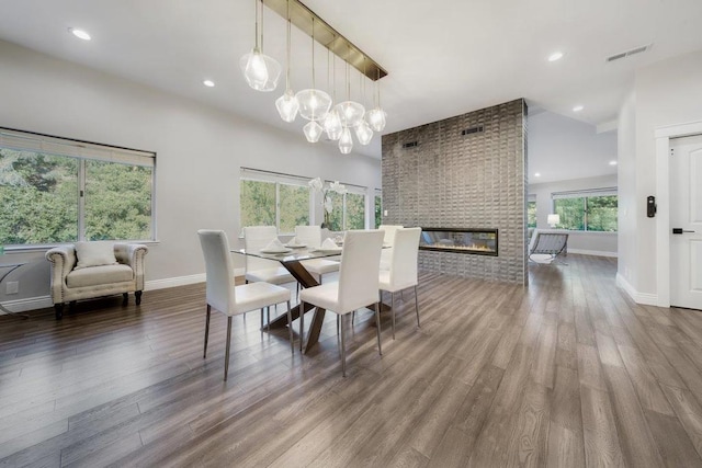 dining area featuring a fireplace and wood-type flooring