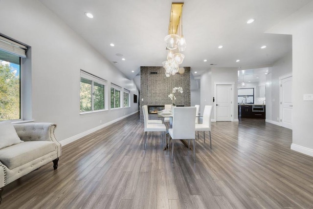 dining area with plenty of natural light, a chandelier, and dark hardwood / wood-style floors