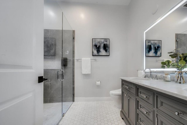 bathroom featuring tile patterned floors, a shower with door, vanity, and toilet