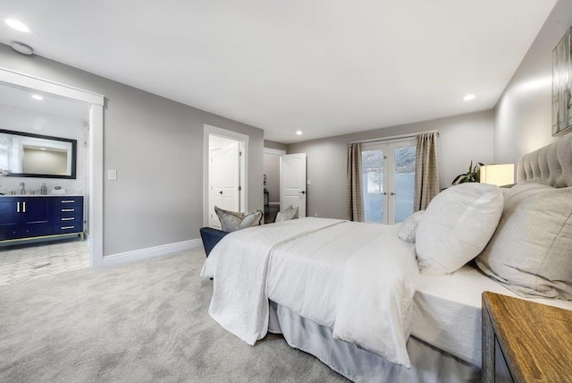 carpeted bedroom featuring french doors, access to outside, and ensuite bathroom