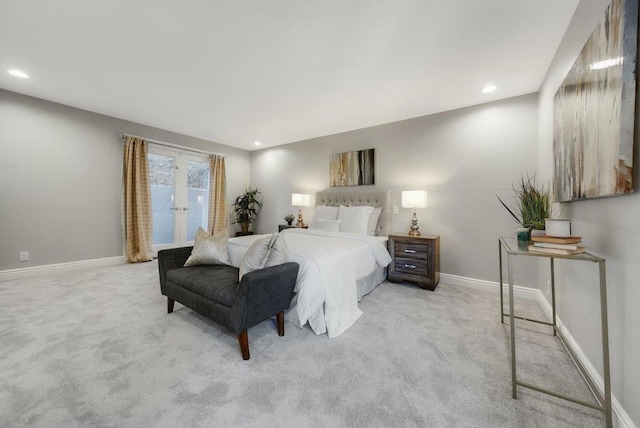 bedroom featuring light carpet and french doors