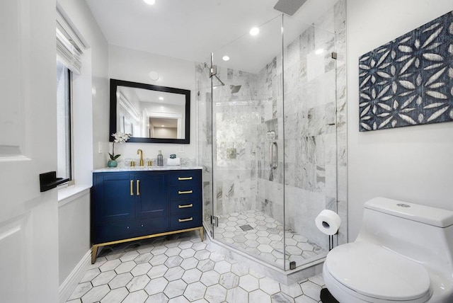 bathroom featuring vanity, toilet, and a shower with shower door