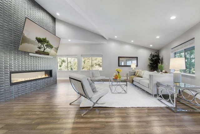 living room with dark hardwood / wood-style floors, a tile fireplace, and vaulted ceiling